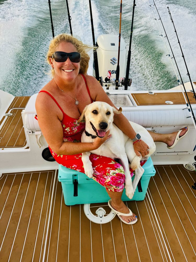 Captain Danielle with dog aboard Salty Adventure Boat Tours
